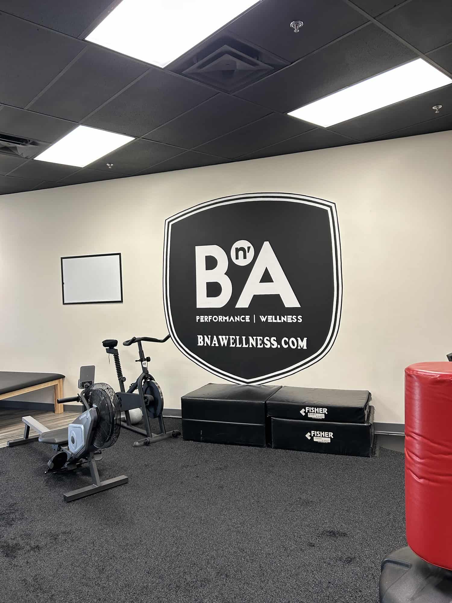 BNA Wellness logo wall and cardio bikes